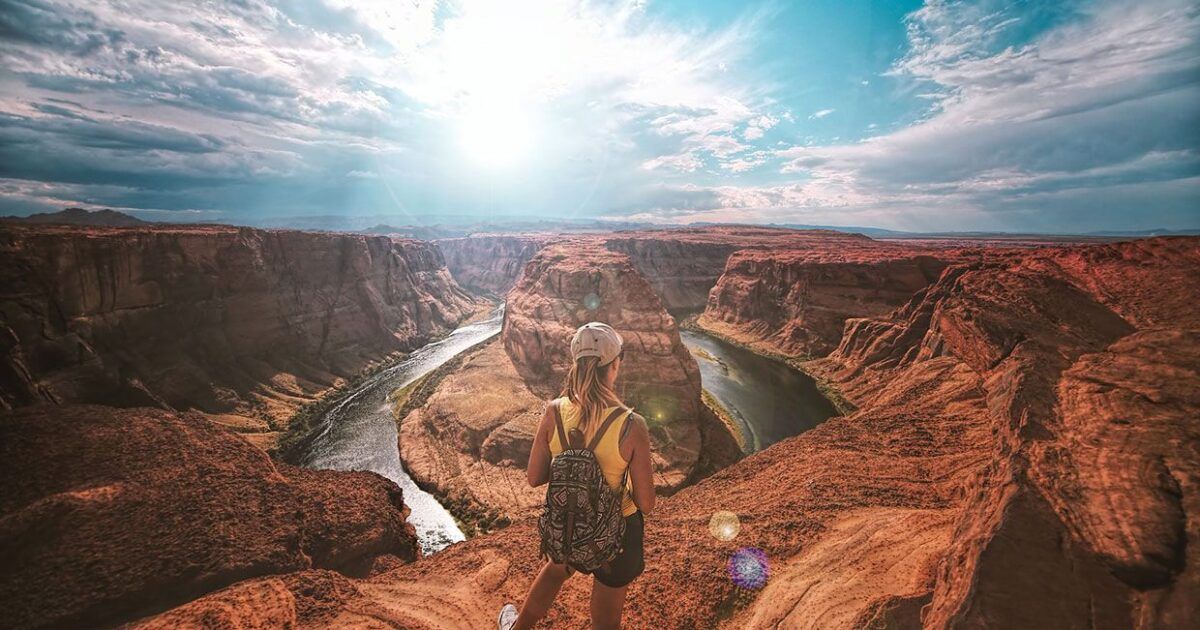 Woman standing on top of canyon