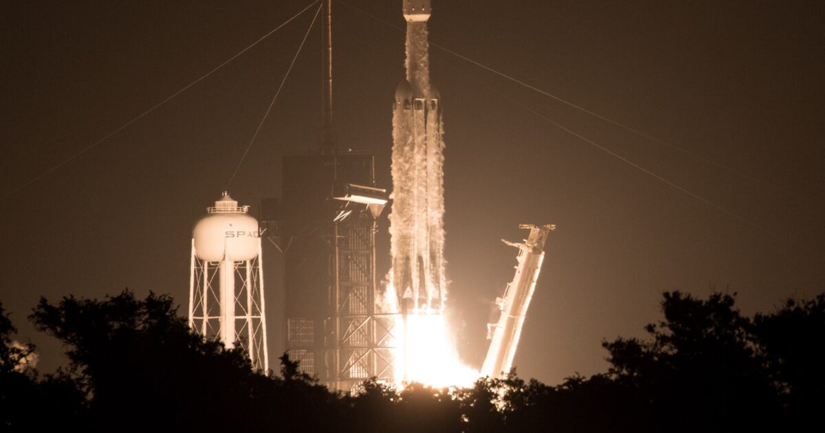 A SpaceX Falcon Heavy rocket lifts off at night from Launch Complex 39A at Kennedy Space Center, Florida.
