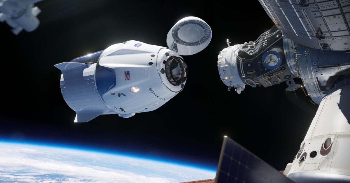 SpaceX Crew Dragon spacecraft approaching the International Space Station for docking, nose cone open showing the docking hardware