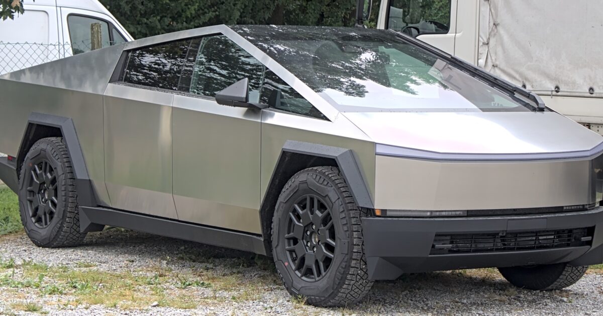 Tesla Cybertruck parked outdoors, used for coverage of the 18-inch steel wheel recall and short-lived RWD trim