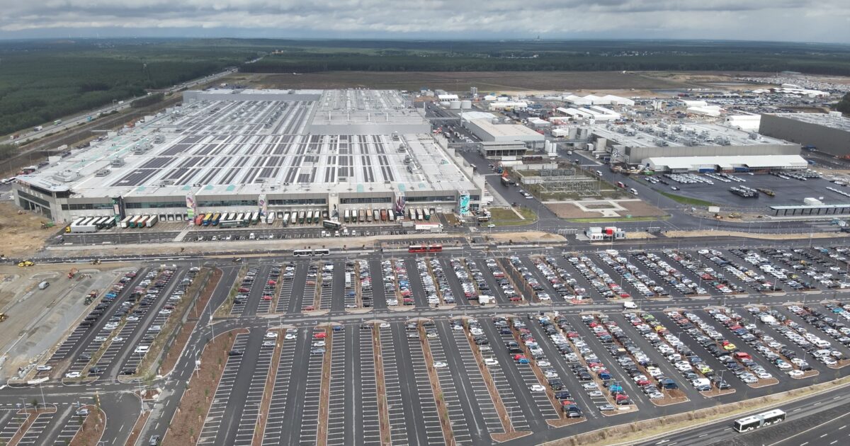 Aerial view of Tesla Gigafactory Berlin-Brandenburg showing massive production facility and parking lots