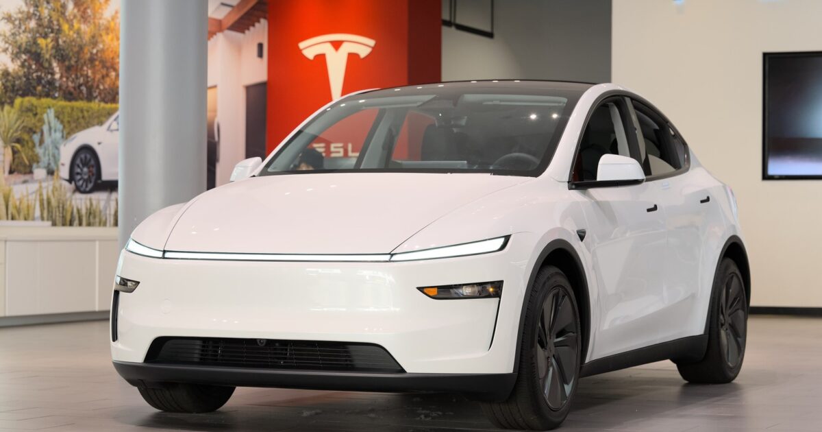 White Tesla Model Y in a Tesla showroom