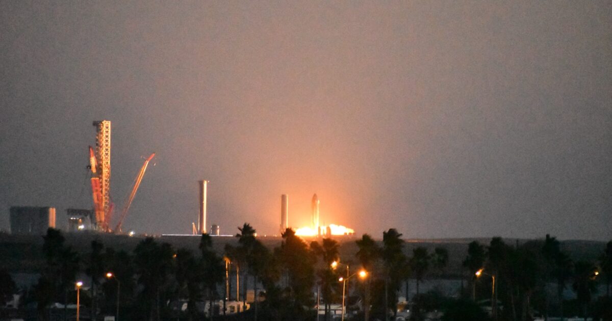 A SpaceX Starship upper stage firing an engine during a nighttime static-fire test at Starbase