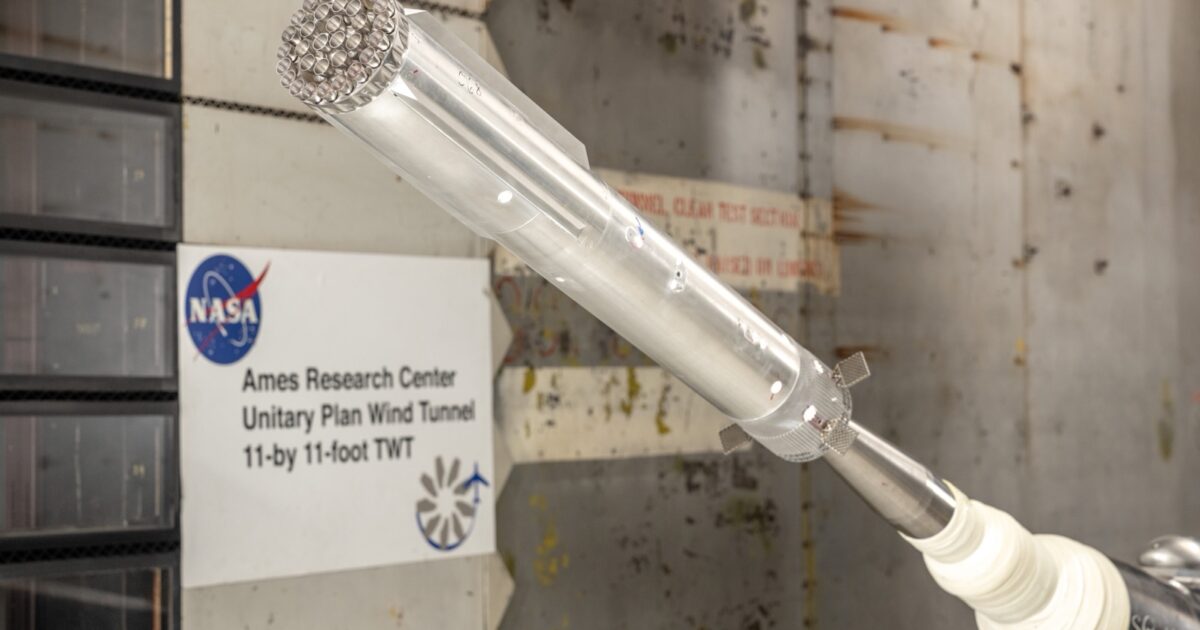 A scale model of SpaceX's Super Heavy booster mounted inside NASA Ames' transonic wind tunnel