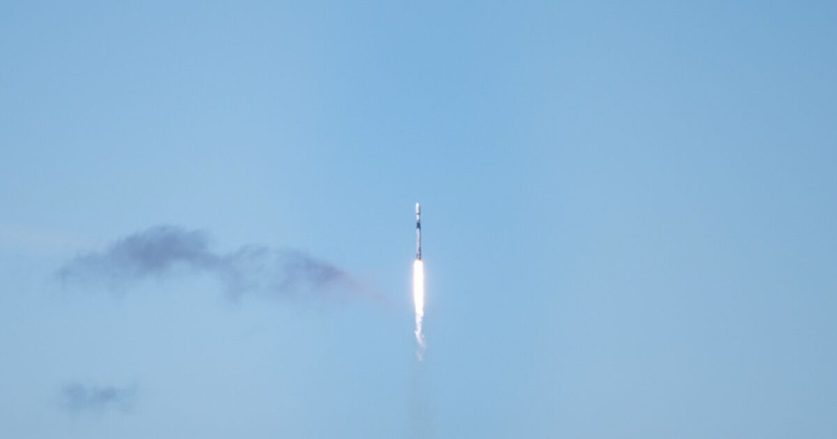 SpaceX Falcon 9 rocket climbing through a blue sky after launch from Vandenberg Space Force Base