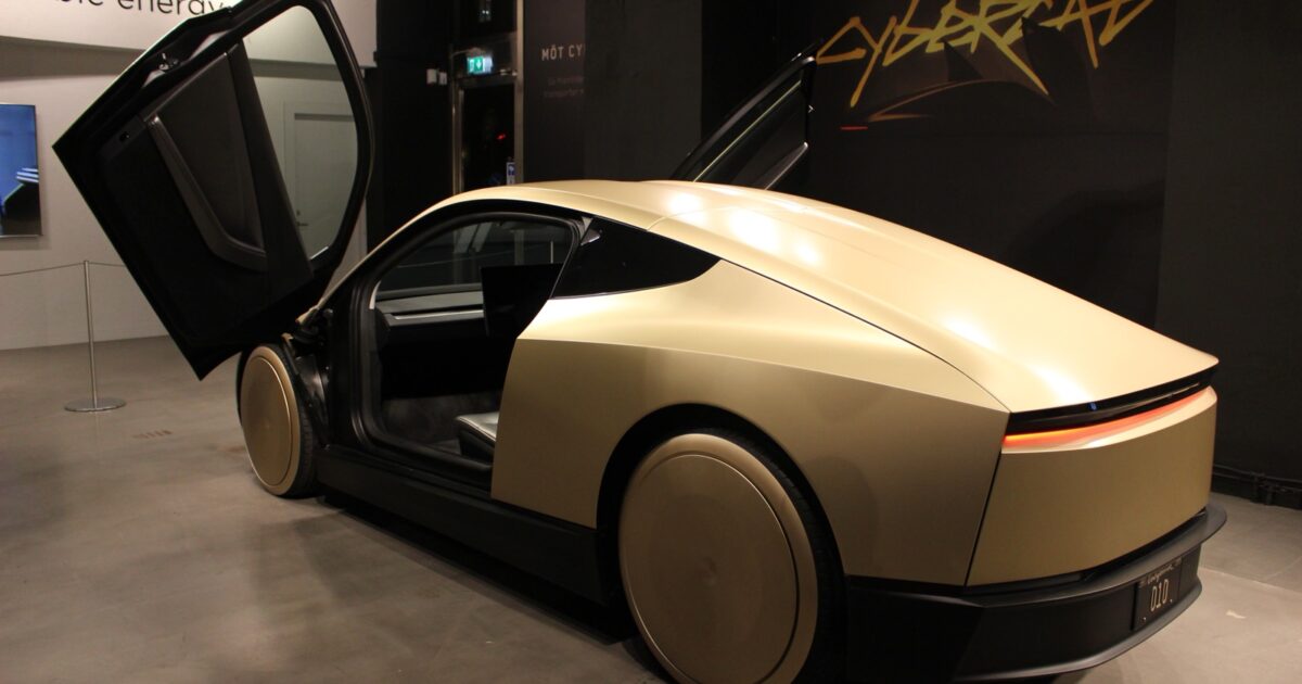 Rear three-quarter view of a Tesla Cybercab with its doors open