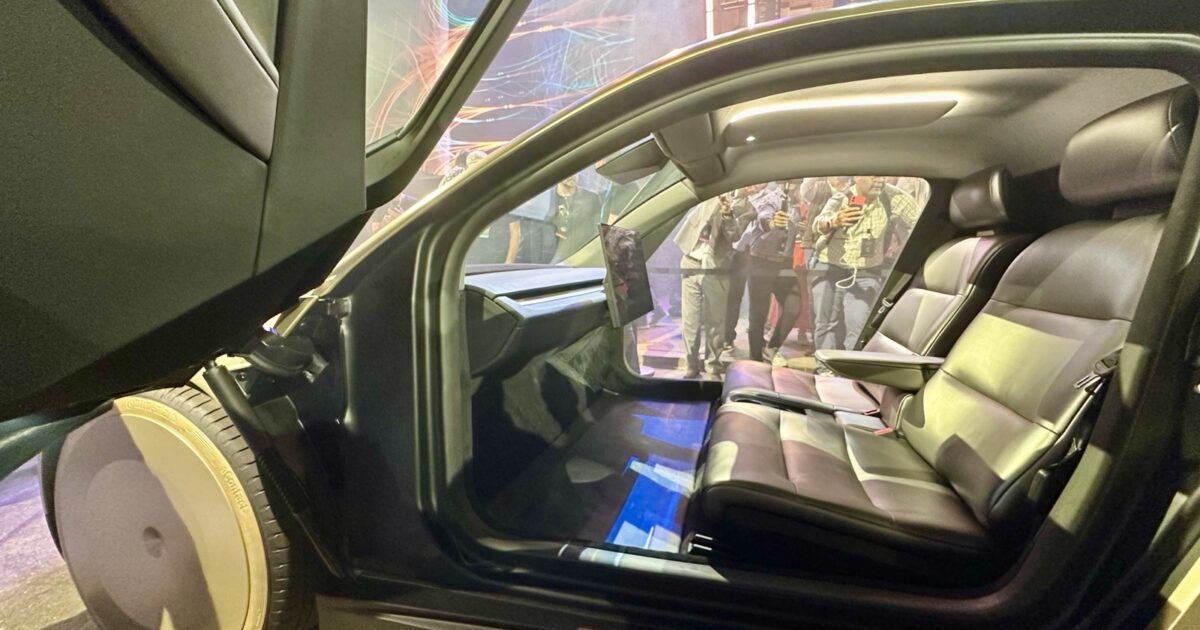 Interior of a Tesla Cybercab showing its central touchscreen and two seats