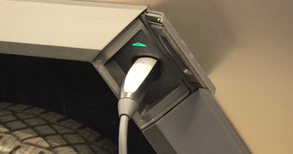 Charging connector plugged into a Tesla Cybertruck
