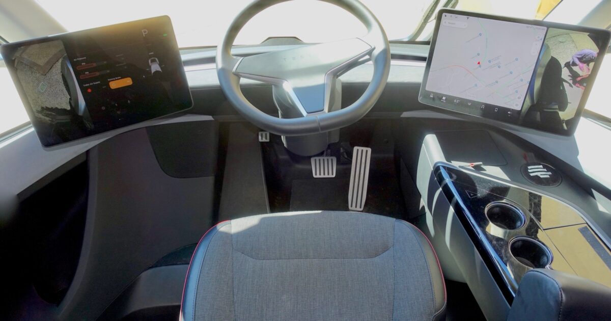 Tesla Semi cockpit with centered steering wheel, dual displays and driver seat