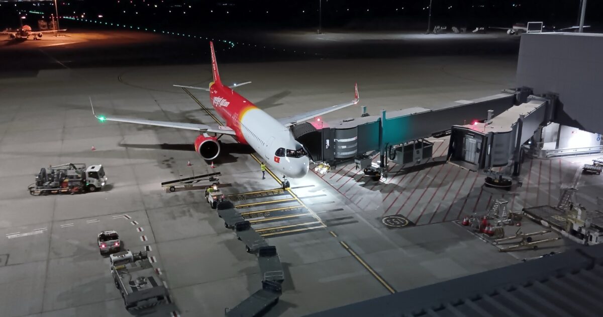 Vietjet Airbus A321neo parked at a gate at Perth Airport at night