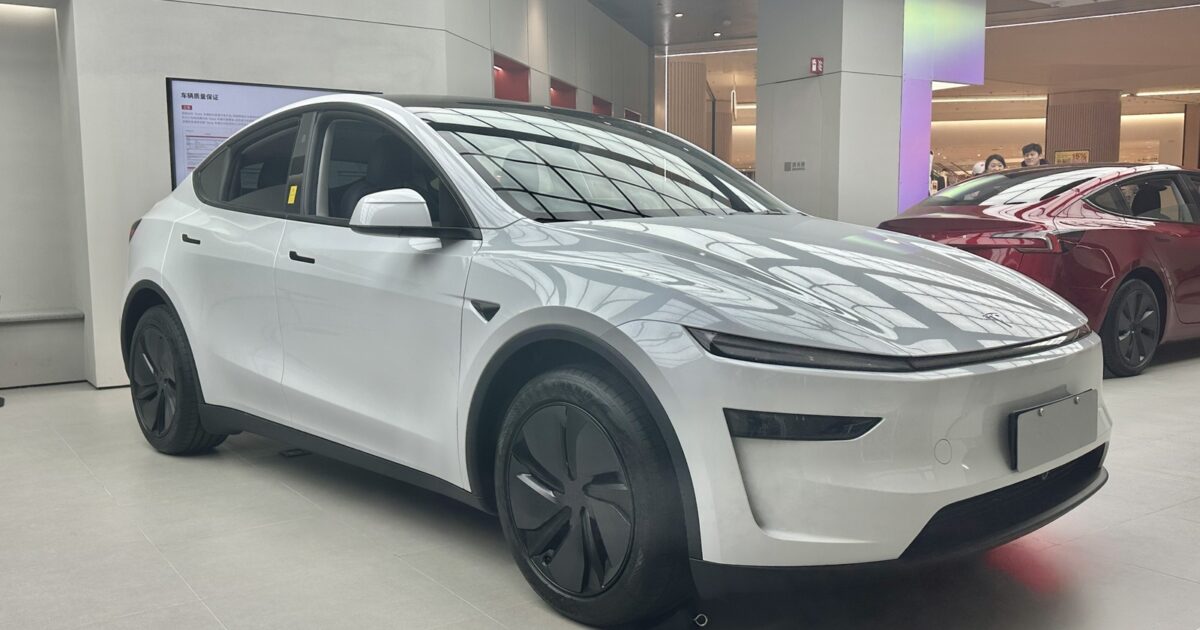 White Tesla Model Y displayed in a showroom